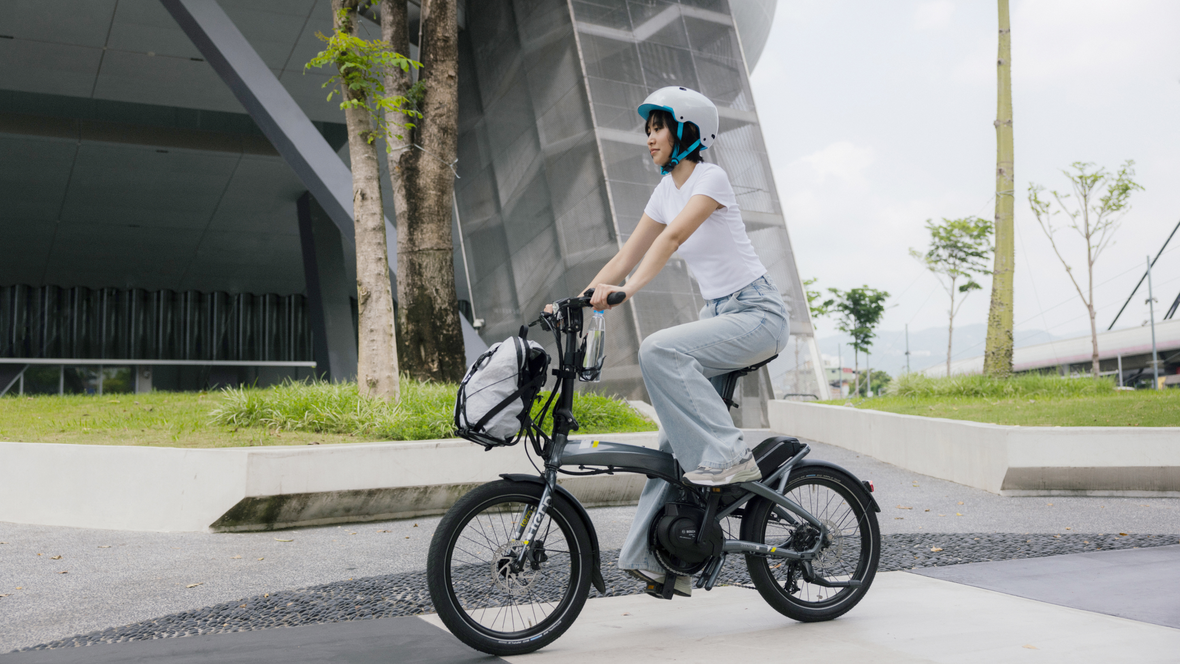 A women wearing jeans rides the Vektron in the city