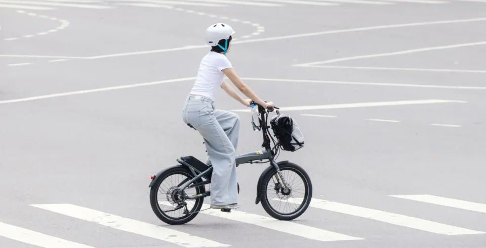 A woman ride the Vektron across the road in the city